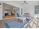 Covered patio featuring a seating area, ceiling fan, and expansive views of the interior living spaces at 82116 Standing Oak Dr, Charlotte, NC 28278