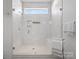Modern shower stall featuring white marble tiling and a glass door at 82116 Standing Oak Dr, Charlotte, NC 28278