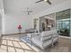 Bright sunroom with modern furniture, ceiling fans, and a view of the kitchen through sliding glass doors at 82116 Standing Oak Dr, Charlotte, NC 28278