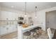 Bright kitchen featuring white cabinetry, an island with seating, and stainless steel appliances at 901 Cathey Rd, Charlotte, NC 28214