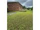 An expansive backyard features a small wooden deck with an entrance to a red brick home at 948 Shannon Bradley Rd, Gastonia, NC 28052