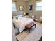 A stylish bedroom with a queen bed, bench, complementary decor, and lots of natural light at 948 Shannon Bradley Rd, Gastonia, NC 28052