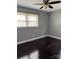 Bedroom with dark hardwood floors, neutral-painted walls, a ceiling fan and a window at 948 Shannon Bradley Rd, Gastonia, NC 28052