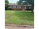 Charming brick home with a well-manicured front lawn and mature trees, offering great curb appeal at 948 Shannon Bradley Rd, Gastonia, NC 28052
