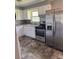 Stylish kitchen featuring a stainless steel fridge and stove and white cabinets at 948 Shannon Bradley Rd, Gastonia, NC 28052