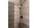 Close up view of shower in a bathroom with a dark faucet and shower head and tile walls at 948 Shannon Bradley Rd, Gastonia, NC 28052