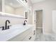 Bathroom with double sinks, an illuminated mirror, and tiled floors at 1010 Wilmouth St, Shelby, NC 28152