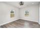 Neutral bedroom with two windows and wood-look flooring at 1010 Wilmouth St, Shelby, NC 28152
