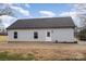 Rear exterior of the house features gray siding, a dark roof, and tidy landscaping at 1010 Wilmouth St, Shelby, NC 28152