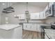 Modern kitchen with white cabinets, granite countertops, and stainless steel appliances at 1010 Wilmouth St, Shelby, NC 28152