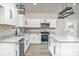 Well-lit kitchen with an island, white cabinets, and stainless steel appliances at 1010 Wilmouth St, Shelby, NC 28152