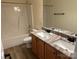 A full bathroom featuring double sinks, granite countertop, and tub with shower at 1043 Boxelder Ln, Charlotte, NC 28262