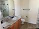 Bathroom featuring double sinks, granite countertop, tiled floor, and tiled shower at 1043 Boxelder Ln, Charlotte, NC 28262