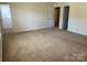 Bedroom featuring neutral carpet, walls and walk-in closet at 1043 Boxelder Ln, Charlotte, NC 28262