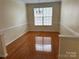 A bright dining room with hardwood floors, a chandelier and lots of natural light at 1043 Boxelder Ln, Charlotte, NC 28262