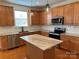 Modern kitchen with stainless steel appliances, granite countertops, and a kitchen island at 1043 Boxelder Ln, Charlotte, NC 28262