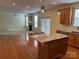 Open concept living with a granite kitchen island, stainless steel appliances, and a cozy fireplace at 1043 Boxelder Ln, Charlotte, NC 28262