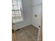 Laundry room with tile floors, a utility sink hookup, and a window with a view of the backyard at 1043 Boxelder Ln, Charlotte, NC 28262