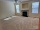 Spacious living room with a fireplace, neutral carpet, ceiling fan and lots of natural light at 1043 Boxelder Ln, Charlotte, NC 28262