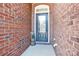 Stylish front door with glass detail and brick surround creates a welcoming entrance at 105 Clarendon St # C, Mooresville, NC 28117