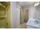 Bathroom featuring double sinks, shower and closet with patterned wall paper at 107 S Myrtle Ave, China Grove, NC 28023