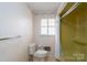 Bathroom featuring toilet and shower with patterned wall paper at 107 S Myrtle Ave, China Grove, NC 28023