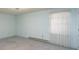 Simple bedroom featuring light blue walls and a window with sheer white curtains at 107 S Myrtle Ave, China Grove, NC 28023