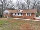 Beautifully designed brick home with a welcoming front porch and expansive lawn at 107 S Myrtle Ave, China Grove, NC 28023