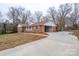 Spacious brick home with an attached garage and long driveway at 107 S Myrtle Ave, China Grove, NC 28023