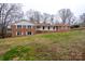 Classic brick residence with a covered front porch nestled on a gently sloping lot at 107 S Myrtle Ave, China Grove, NC 28023