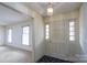 Bright foyer featuring paneled front door with sidelights, chandelier and access to living space at 107 S Myrtle Ave, China Grove, NC 28023