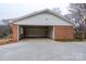 Two-car garage featuring a brick exterior and ample space for parking and storage at 107 S Myrtle Ave, China Grove, NC 28023