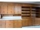 Expansive oak cabinets and shelving offer ample storage space in this kitchen with wood paneled walls at 107 S Myrtle Ave, China Grove, NC 28023