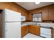 Functional kitchen with wooden cabinets, laminate countertops and ample natural light at 107 S Myrtle Ave, China Grove, NC 28023