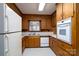 Clean kitchen featuring wooden cabinets, laminate countertops and modern appliances at 107 S Myrtle Ave, China Grove, NC 28023