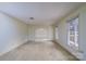 Spacious living room with neutral carpet, natural light, with doorway leading into dining room at 107 S Myrtle Ave, China Grove, NC 28023