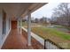 Covered porch with brick-patterned flooring and white columns offer outdoor relaxation at 107 S Myrtle Ave, China Grove, NC 28023