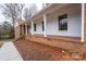 Inviting front porch with classic columns, brick base, and access to the main entrance at 107 S Myrtle Ave, China Grove, NC 28023