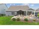 Exterior view of a home with a backyard patio featuring a pergola, lounge chairs, and outdoor seating at 1082 Dorsey Dr, Fort Mill, SC 29715