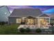The lovely home features a patio area with a pergola, lounge seating, and a cozy outdoor fire pit at 1082 Dorsey Dr, Fort Mill, SC 29715