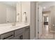 Well-lit bathroom featuring a vanity with gray cabinets, a white countertop, and a view into an adjacent bedroom at 1082 Dorsey Dr, Fort Mill, SC 29715