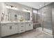 Modern bathroom with a double vanity, large mirror, and a luxurious glass-enclosed shower at 1082 Dorsey Dr, Fort Mill, SC 29715