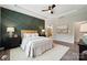Bedroom features an accent wall, ceiling fan, decorative lamps, and hardwood floors at 1082 Dorsey Dr, Fort Mill, SC 29715
