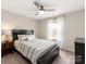 Inviting bedroom with ceiling fan, a dark wood bed frame, carpet flooring, and a dresser at 1082 Dorsey Dr, Fort Mill, SC 29715