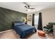 Well-appointed bedroom with a modern accent wall, cozy rocking chair, and a ceiling fan at 1082 Dorsey Dr, Fort Mill, SC 29715
