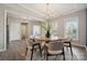 Elegant dining room with a round table, chandelier, and large windows, perfect for entertaining at 1082 Dorsey Dr, Fort Mill, SC 29715