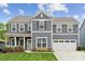 Beautiful two-story home featuring a manicured lawn and a two-car garage, perfect for Gathering living at 1082 Dorsey Dr, Fort Mill, SC 29715