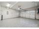 Spacious garage featuring epoxy flooring, modern lighting and a secure automatic door system at 1082 Dorsey Dr, Fort Mill, SC 29715
