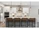 Bright, modern kitchen with a large island, stainless steel appliances, and stylish pendant lighting at 1082 Dorsey Dr, Fort Mill, SC 29715