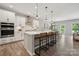 Bright, modern kitchen with a large island, stainless steel appliances, and stylish pendant lighting at 1082 Dorsey Dr, Fort Mill, SC 29715